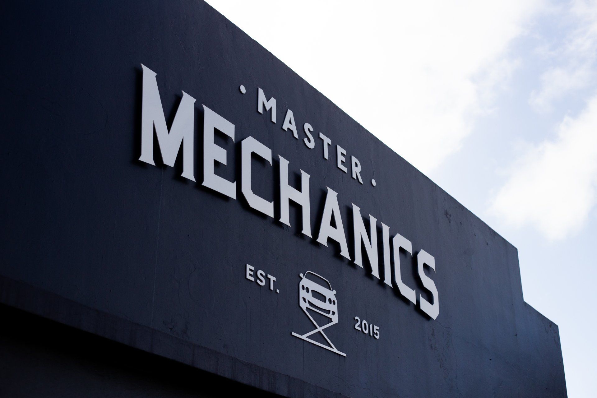 Close-up of the Master Mechanics sign above the workshop